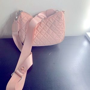 Pink purse with side phone holder.